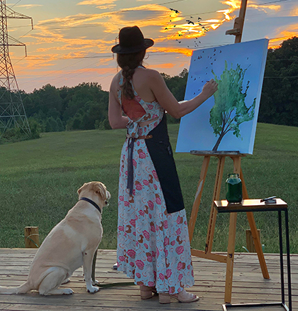 Nancy Joyce painting on a farm